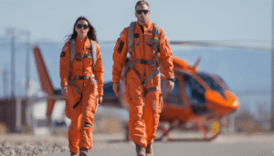 An Air Methods pilot and flight nurse walking together in branded flight suits, showcasing the professional teamwork and coordinated response essential to a leading air medical service.