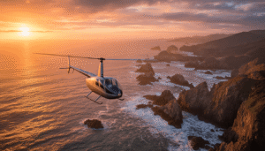 A scenic helicopter tour at sunset along a stunning coastline, viewed from the cockpit, showcasing the idyllic and rewarding work environment of a tour pilot.