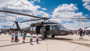 A National Guard helicopter parked at a local community airshow, with pilots engaging with the public to foster connections and demonstrate their role within the state.