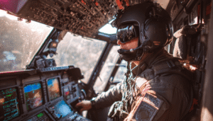 A police helicopter pilot and a Tactical Flight Officer (TFO) coordinating closely in the cockpit during a mission, with the TFO operating surveillance equipment while the pilot flies the aircraft.